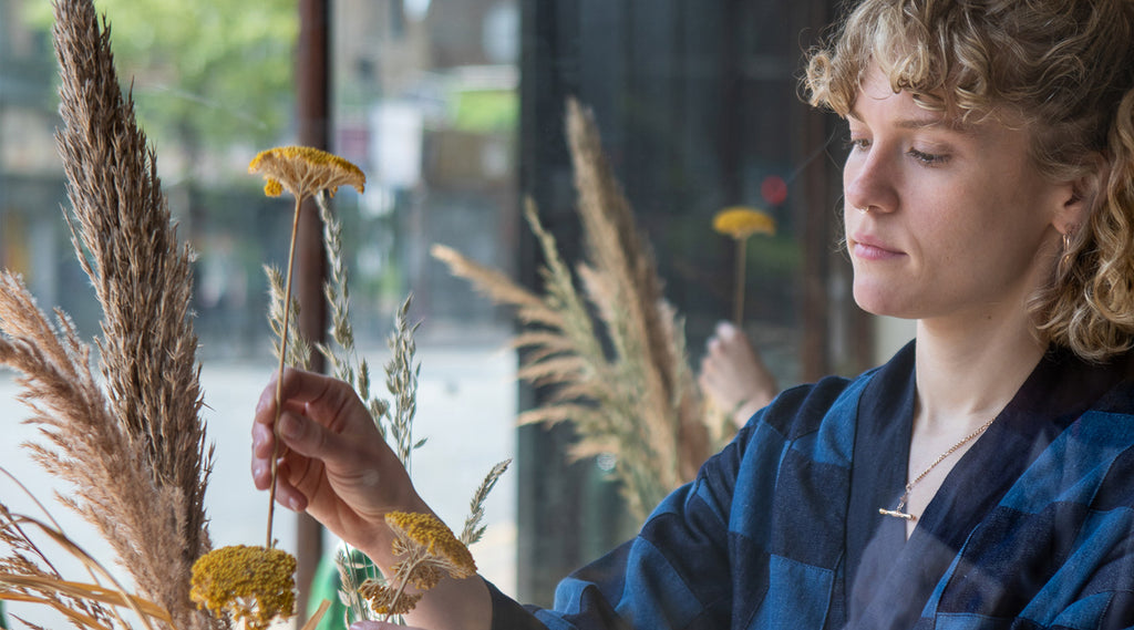 Taylor holding flowers at hackney road shop a new tribe