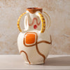 Ceramic vase with abstract design on a beige background