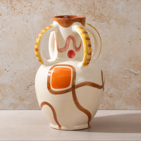 Ceramic vase with abstract design on a beige background