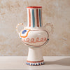 Decorative ceramic LRNCE vase with colourful patterns on a beige background