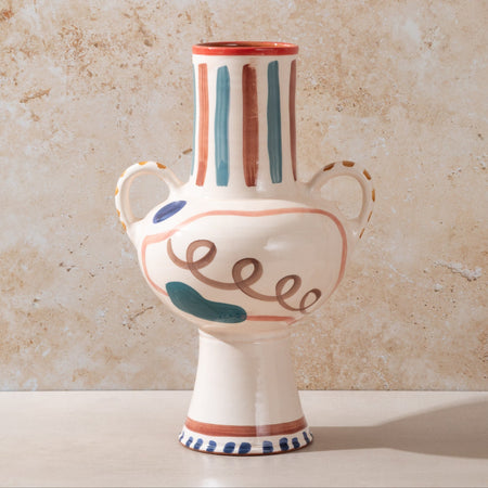 Decorative ceramic vase with colorful patterns on a beige background