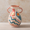 Ceramic vase with colorful patterns on a beige background