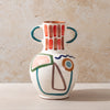 Ceramic LRNCE vase with abstract design on a beige background