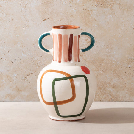 Ceramic vase with abstract design on a beige background