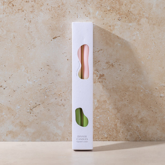 White candle packaging with a pink wick on a beige stone background