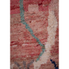 Close up of a Moroccan Berber hand-made Boujad wool rug available to buy with an abstract design in pink, red and cream.