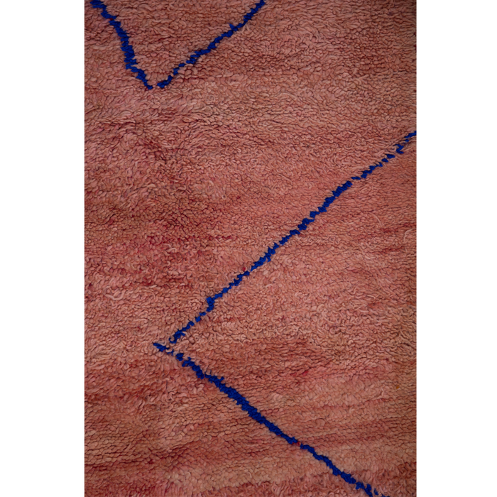 Peachy pink Moroccan Berber rug with a simple linear design in cobalt blue.