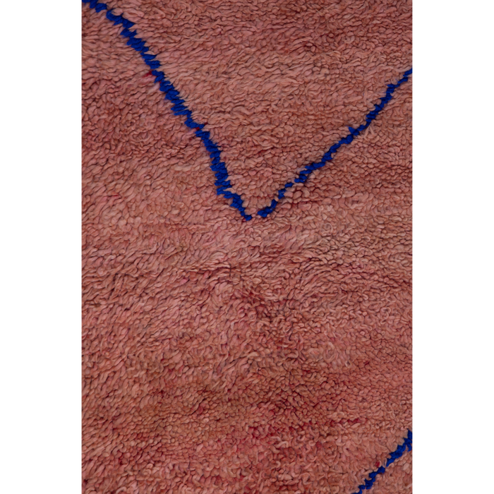 Peachy pink Moroccan Berber rug with a simple linear design in cobalt blue.