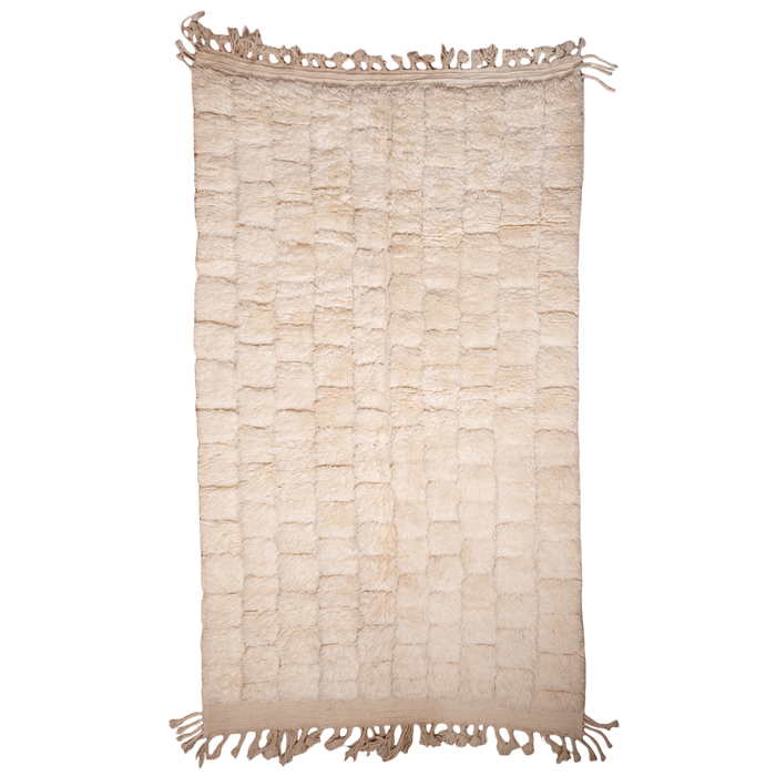 Beige woven rug with tassels on a white background