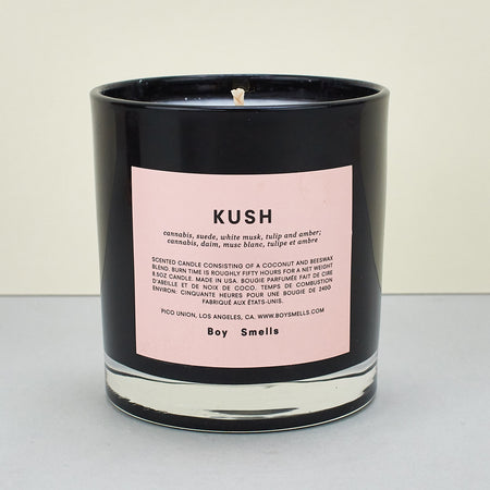 black candle with pink label 
