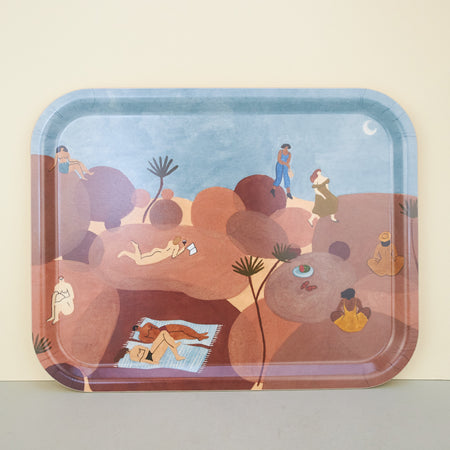 tray in blue and brown. Illustrations pf people lying on brown rocks across a blue sky with a moon in the desert.. 