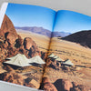 coffee table book remote places travel open book desert