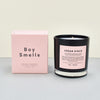  ‘Cedar Stack’ scented candle by Boy Smells. light pink box with black candle. 