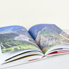 coffee table book remote places travel open book mountains