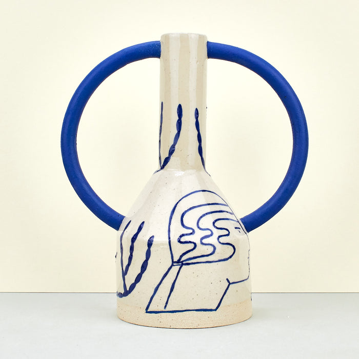 beige ceramic vase interior design with blue handles and blue illustrations. 
