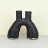 Hand-built sculptural ceramic vase or candle holder with double opening, in black.