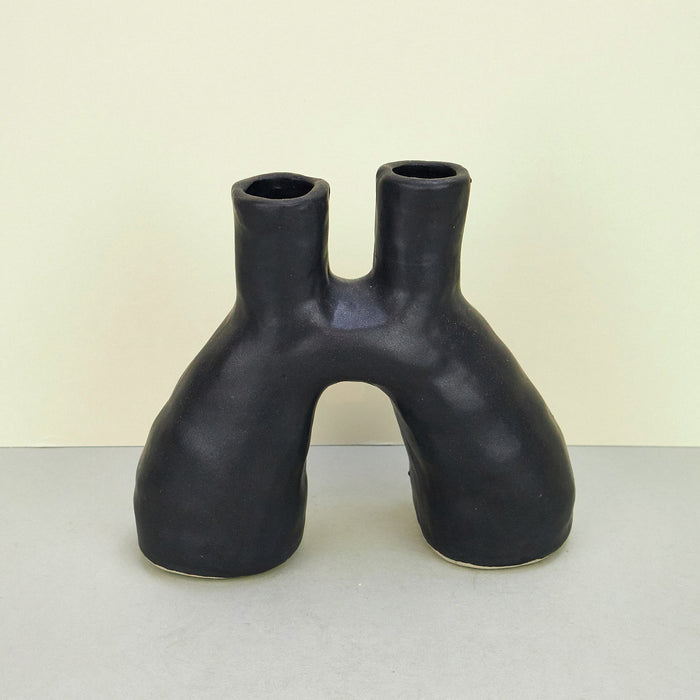 Hand-built sculptural ceramic vase or candle holder with double opening, in black.