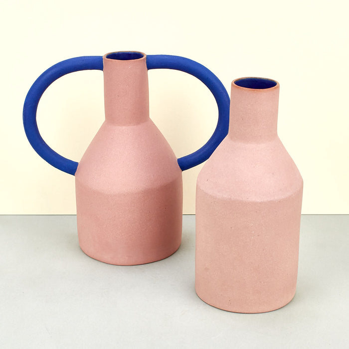 Matte pink vases with cobalt blue internal glaze one with blue handles