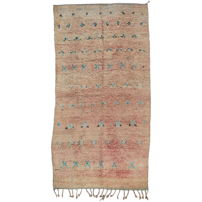 Moroccan vintage berber boujad rug has a soft pink and peach toned base with a motif design in turquoise, cream, black.