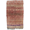 Moroccan vintage berber boujad rug has a warm red and pink toned base with an intricate design in brown, grey and cream with a stripe of purple