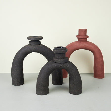 candle holders with sculptural neck designs made by terracotta clay in black and red