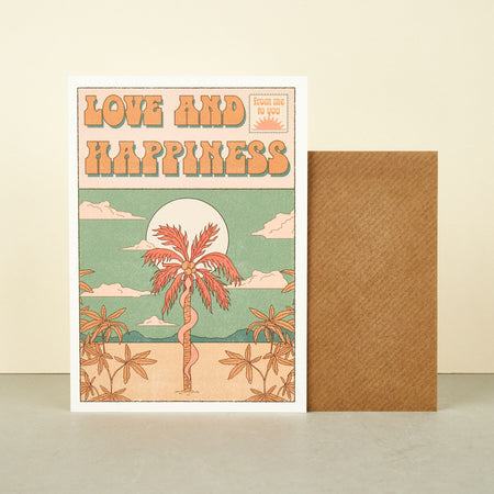 card in pastel colours with copy love and hapipiness image of a snake climbing up a palm tree in the desert