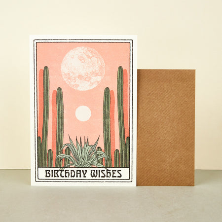 'Birthday Wishes' card by Cai & Jo. Illustration of sun and moon in desert with cactus, cacti. 