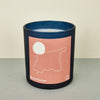 moroccan black candle with a pink label with an outline of morocco.