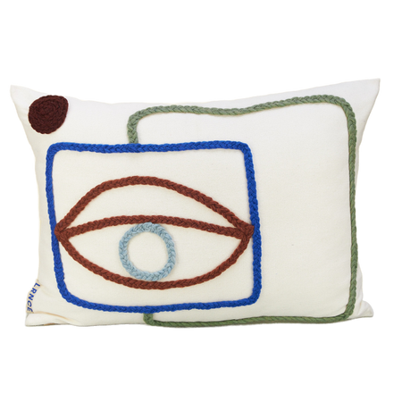 moroccan textile, white pillow with woven details in green, blue and brown. 