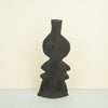 ribbed ceramic rustic vase in black on a plain background. 
