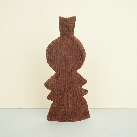 ribbed ceramic rustic vase in brown on a plain background. 