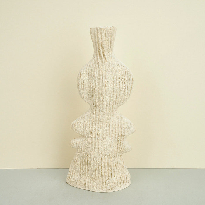 ribbed ceramic rustic vase in beige on a plain background. 