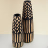 hand-carved floor vase made of paulownia wood. two black vases with beige wood patterns. 