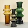 Sculptural-shaped ribbed glass vases in mustard and green dyed glass
