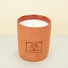 terracotta candle on plain background. 