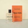 perfume bottle next to orange perfume box CRA-YON