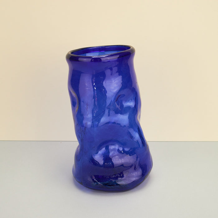 Limited edition cobalt blue glass vase by Kana London. Vase on a plain background. 
