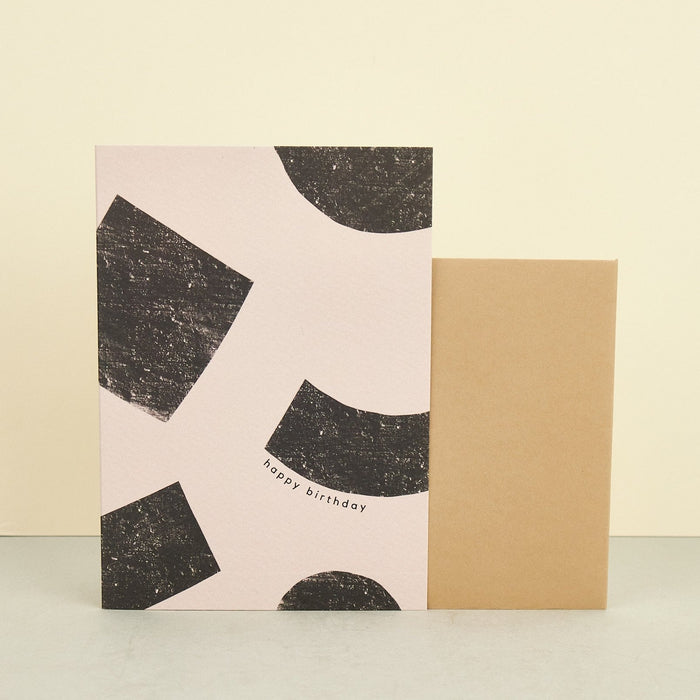 birthday card beige background with black geometric blocks. 