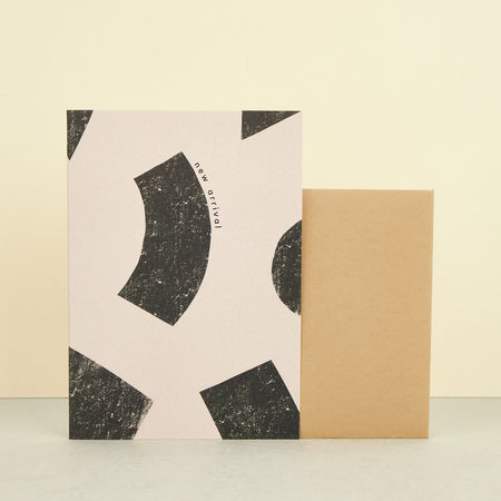 beige card with black geometrical prints with copy new arrival