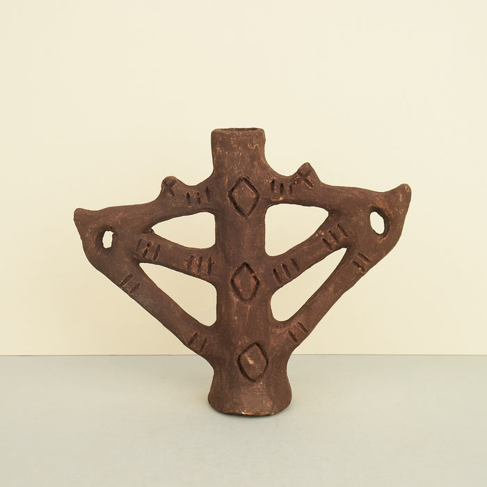 brown moroccan ceramic candleholder on a plain background. 