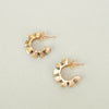 'Fern' Stud Hoops by Nagle & Sisters gold hooped earrings on a plain background