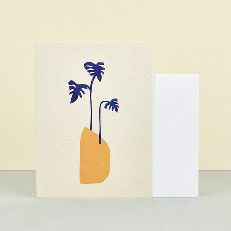  'Blue Leaves' Letterpress Card illustrated by B.D. Graft for stationary business Wrap. Beige background with pot in yellow and three plant leaves in blue. 