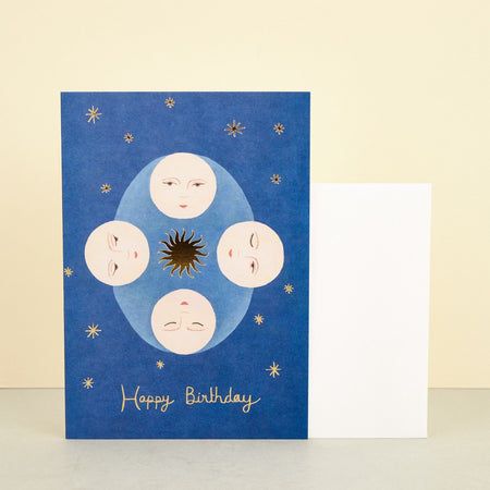 birthday card with illustrated moons and stars on a blue background. 