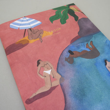 notebook of illustration featuring a beach and nude women. 